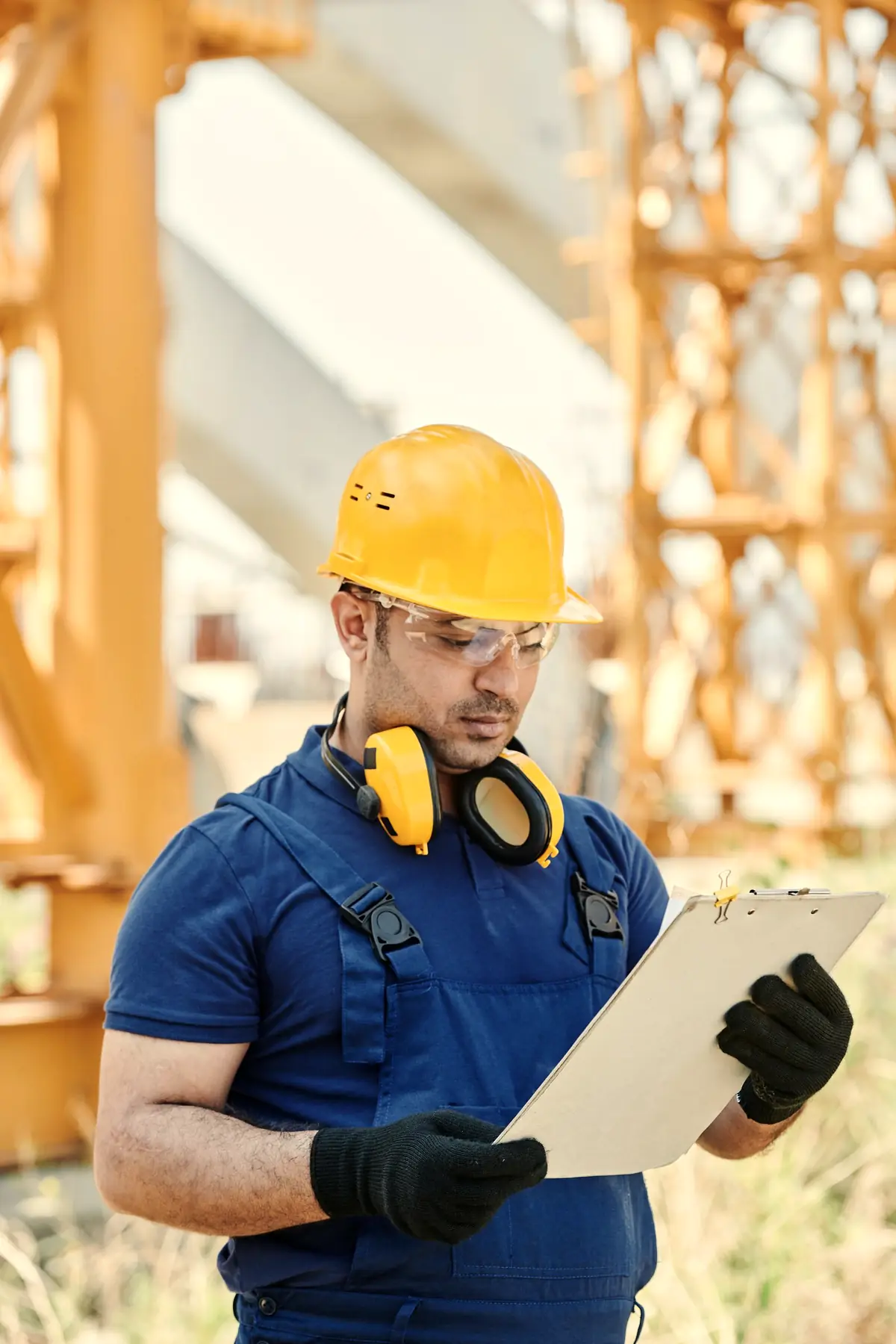 A crew member on a job site photographs the finished work with a phone.